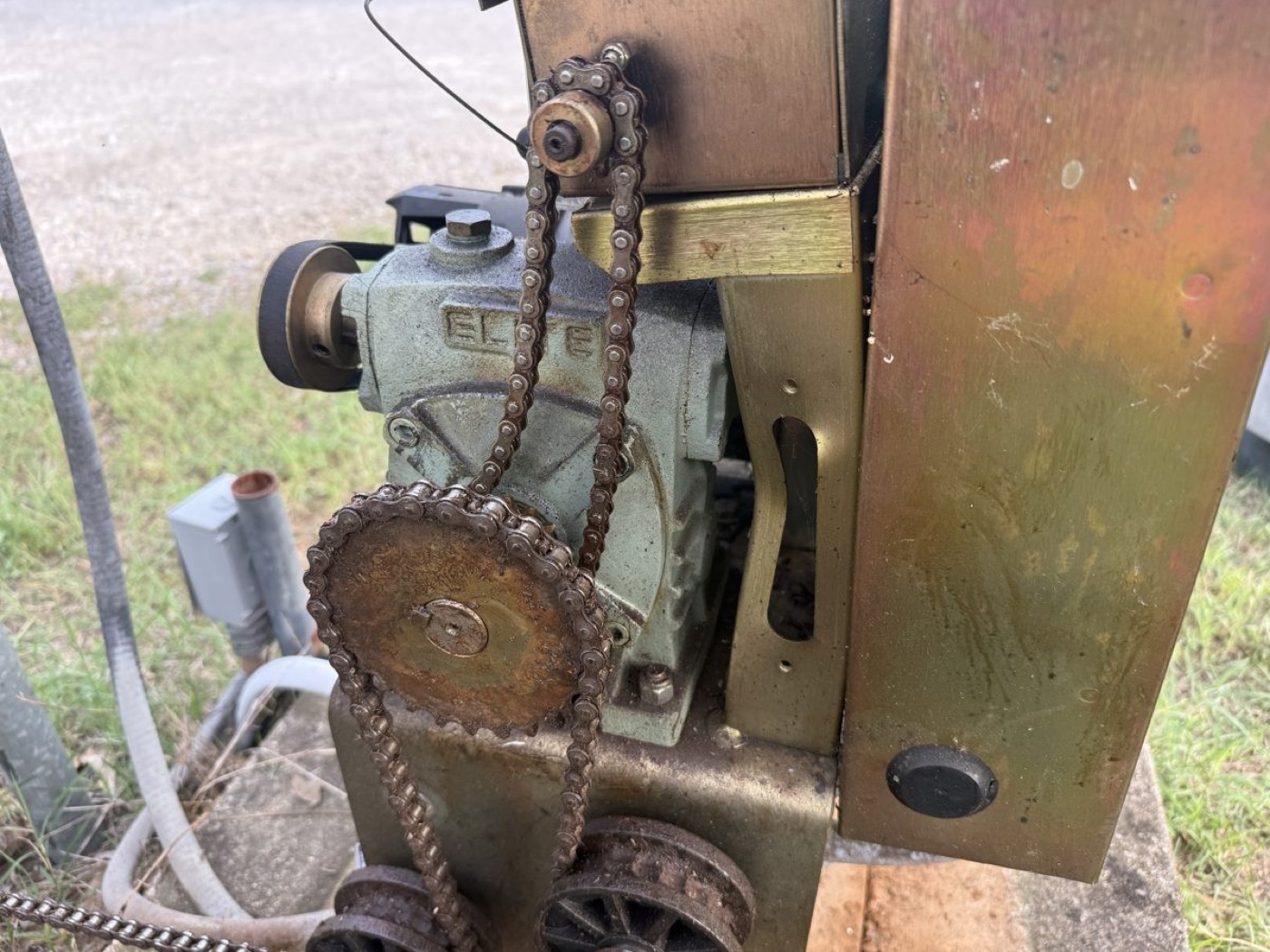 The corroded drive chain and sprocket of the second gate operator